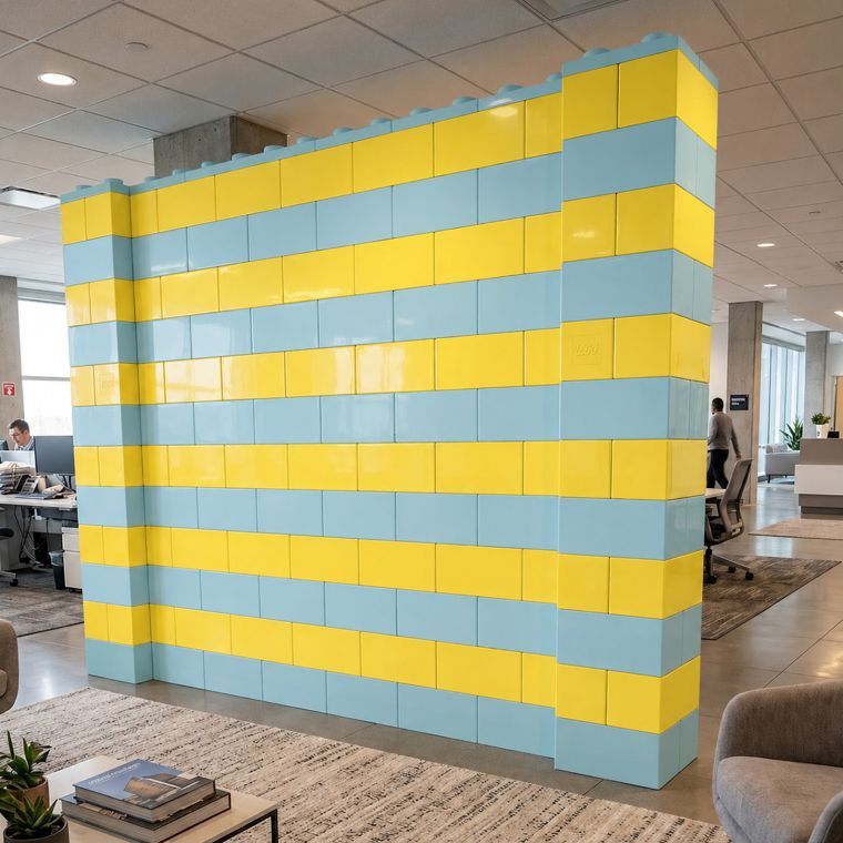 Blue and yellow modular block wall divider in a modern open office.